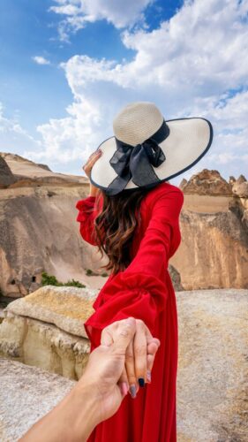 women tourists holding man s hand leading him fairy chimneys cappadocia turkey 1 e1764058986175
